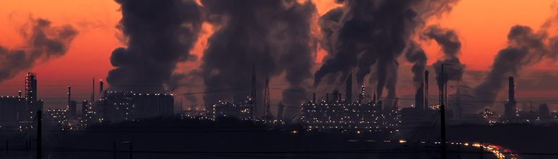 Smoke emitting from power plants over a dark city