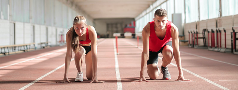 A woman and a man prepare to race each other